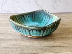Wheel-thrown ceramic bowl altered with carving and coiling