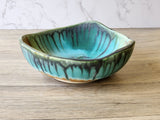 Wheel-thrown ceramic bowl altered with carving and coiling