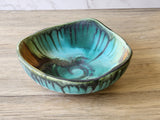 Artisan pottery serving dish with layered glazes