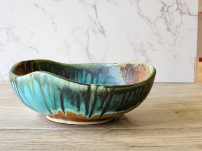 Unique handmade pottery bowl with organic carved form