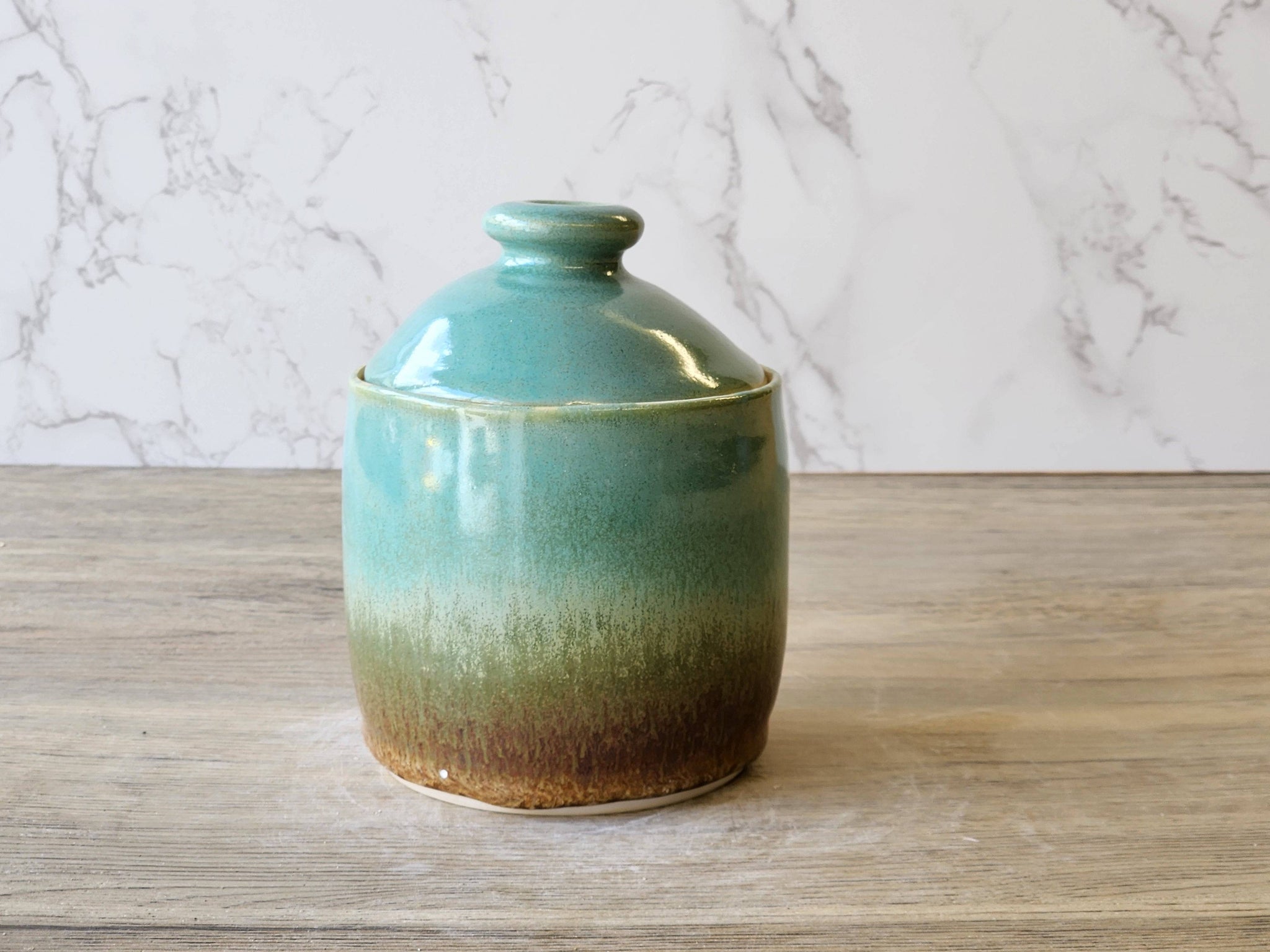 Tall pottery jar with dome lid – brown and green glaze detail