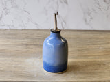 Stoneware olive oil bottle with dark glaze finish