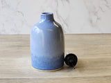 Rustic pottery olive oil pourer with ergonomic design