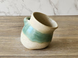 Wheel-thrown ceramic salt pig in cream and green glaze