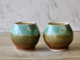 Pottery teacup with spearmint and brown mottled glaze