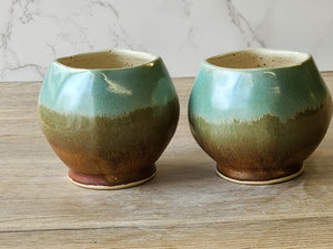 Artisan pottery tea mug with cream and brown glaze