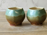Artisan pottery tea mug with cream and brown glaze
