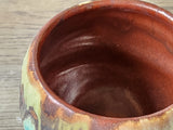 Internal look at the burgundy glaze of the Wheel-thrown yunomi pottery cup 