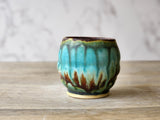 Handmade Wheel-thrown yunomi pottery cup in moss green, brown, burgundy and turquoise glazes.