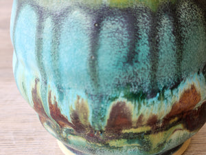 Close up of the Handmade Pottery tea cup in rustic turquoise and brown glaze