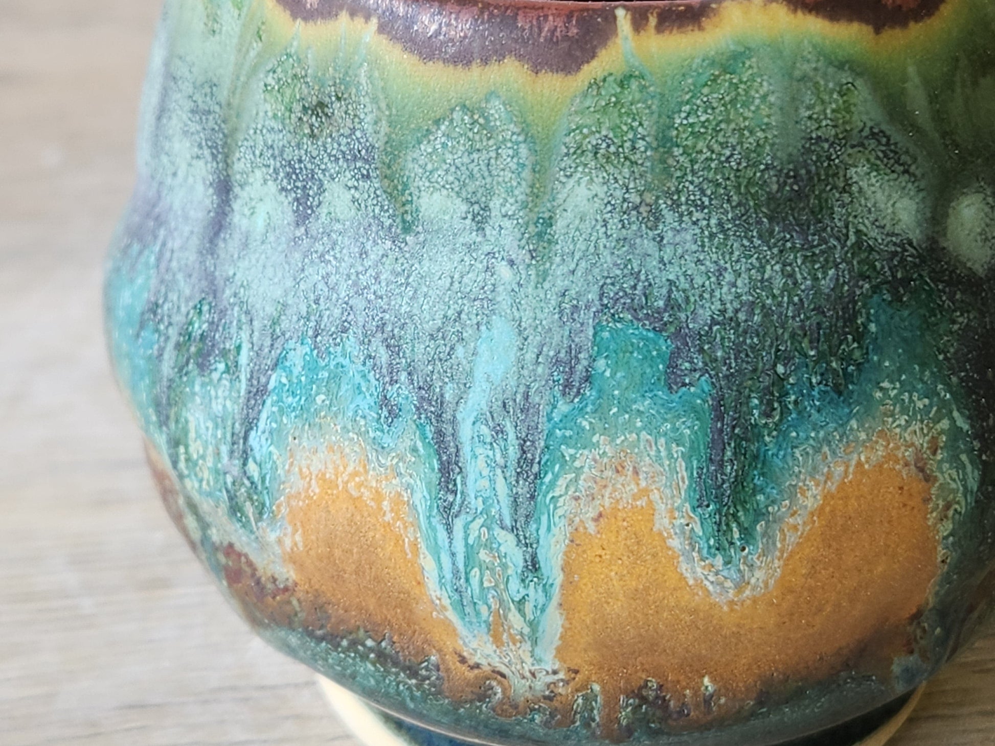 Close up of mottled glazes on the handmade pottery teacup