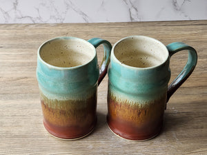 Tall pottery steins glazed in green and rust layers