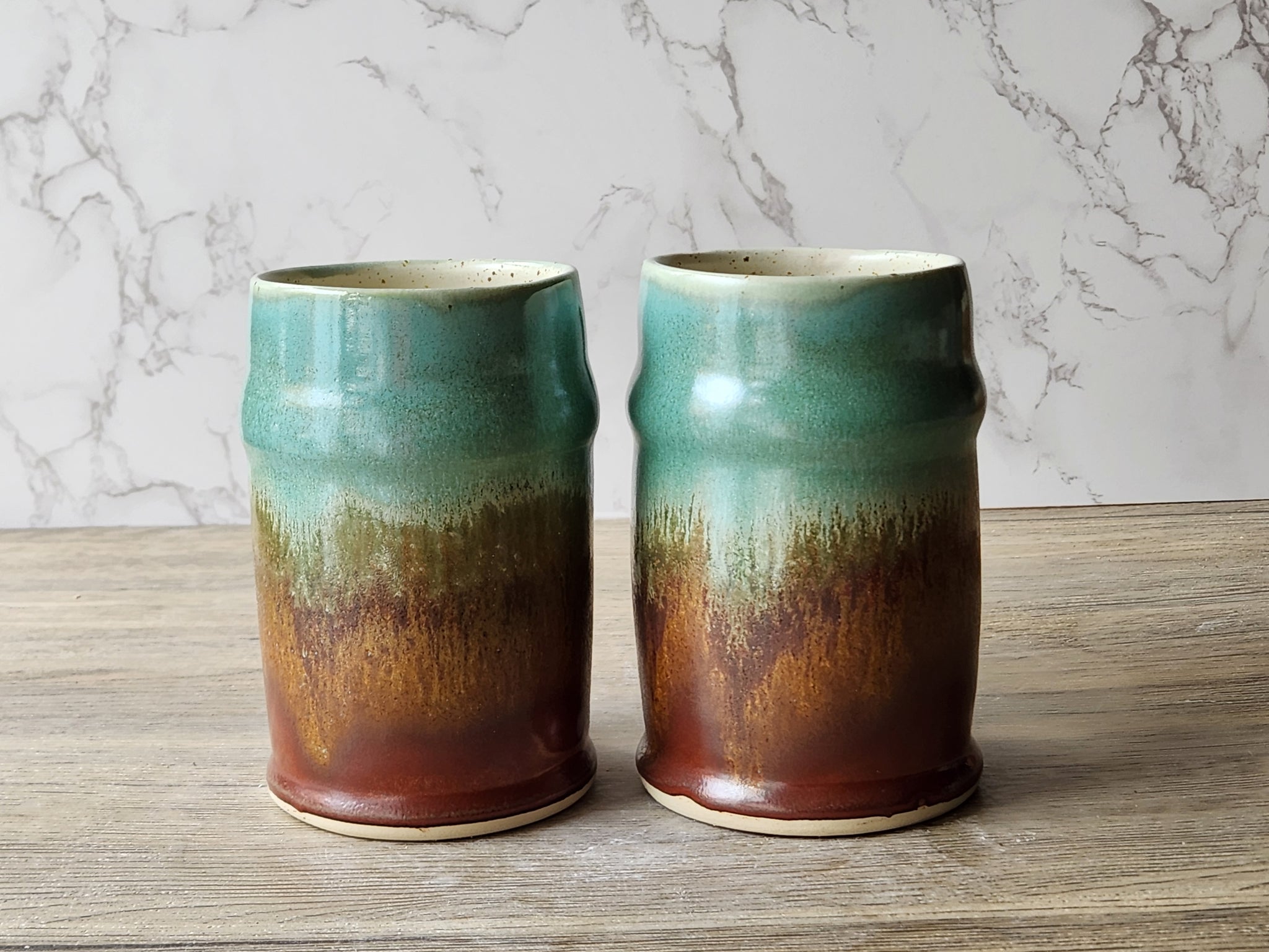 Handmade pottery beer steins with green amber glaze