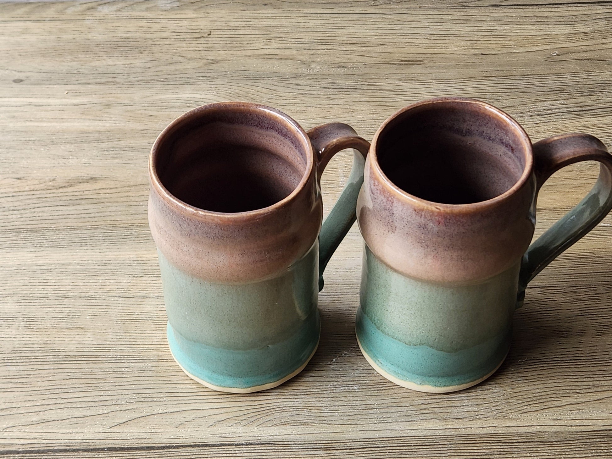 Tall ceramic steins with soft brown rim glaze