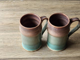 Tall ceramic steins with soft brown rim glaze