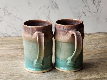 Artisan pottery steins with green and tan glaze blend