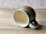 Rustic handmade pottery mug in Australian landscape tones