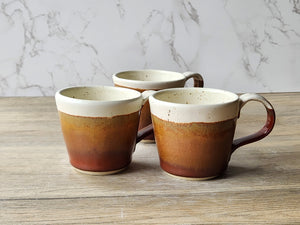 Handmade ceramic espresso cups in brown and cream