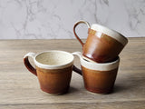 Artisan espresso cup with speckled cream and brown glaze