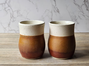 Rustic handmade ceramic cup in cream and brown glaze