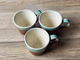 Small handmade ceramic coffee mug 150ml lined in a speckled cream glaze.