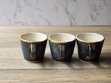 Unique pottery espresso mug with rim highlights