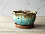 Rustic ceramic berry strainer bowl in green glaze