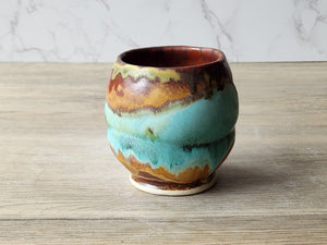 Rustic yunomi cup with flowing glaze design for tea or as a whisky sipper.
