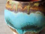 Close up of Pottery tea cup with horizon band glaze pattern