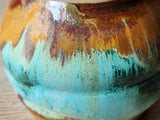 Close up of Stoneware yunomi cup with earthy layered glaze