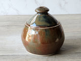 Rustic pottery sugar jar with bronze glaze and lid