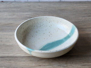 Handmade pottery pasta dish with green glaze accent