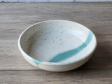 Handmade pottery pasta dish with green glaze accent
