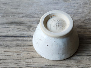 Speckled buttermilk ceramic bowl with green glaze accent