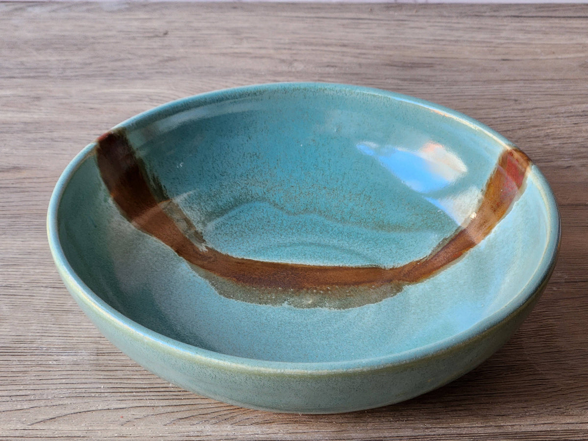 Handmade pottery dessert bowl with green and brown glaze