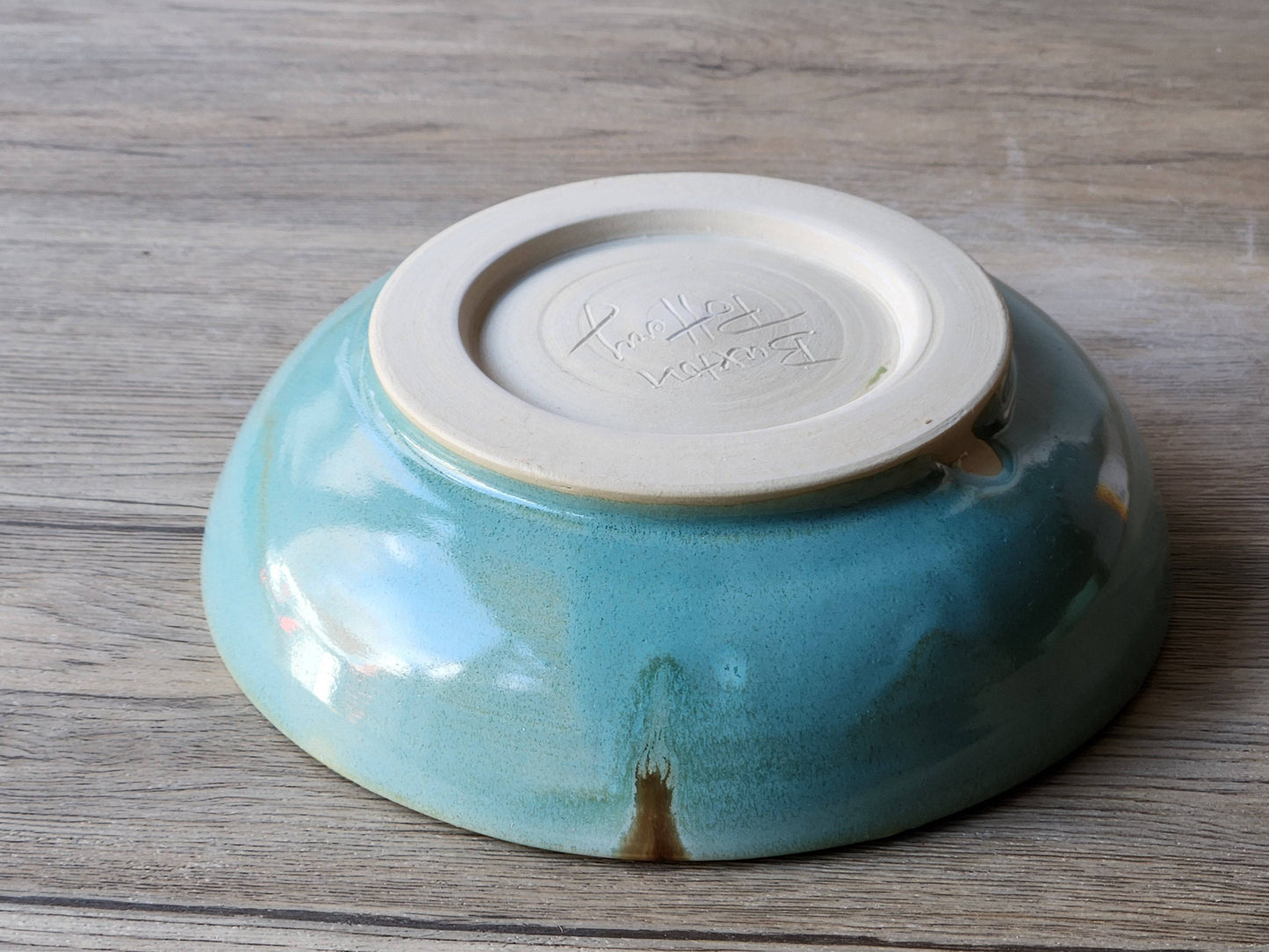Underside of Unique handmade ceramic dinnerware spearmint green glaze