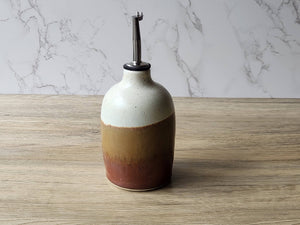 Ceramic olive oil dispenser that protects oil from light