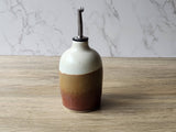 Ceramic olive oil dispenser that protects oil from light