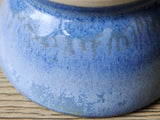 Close up of blue glaze on the small trinket dish