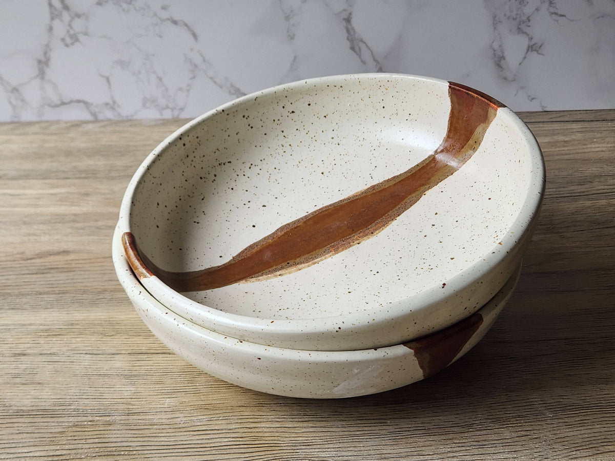 Speckled cream stoneware bowl with unique glaze variations