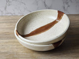 Speckled cream stoneware bowl with unique glaze variations