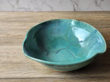 Wheel-thrown pottery bowl with natural glaze variations
