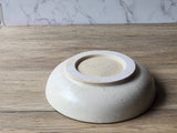 Minimalist ceramic pasta or salad bowl in speckled cream