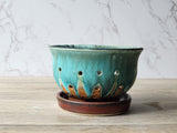 Wheel-thrown ceramic berry strainer with rustic glaze finish