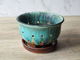 Rustic pottery colander for washing and serving fresh berries