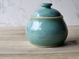 Rustic ceramic sugar pot with glossy white interior