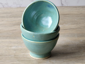Handmade stoneware condiment bowl with glossy green-blue glaze