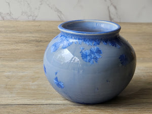 Crystalline pottery bowl with glossy white interior