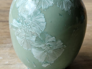 Porcelain vase with soft blue crystal patterns shown up close