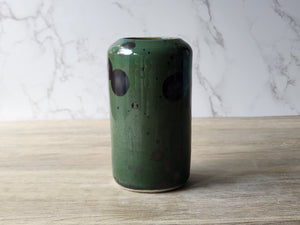 Wheel-thrown porcelain vase with dark crystal growths